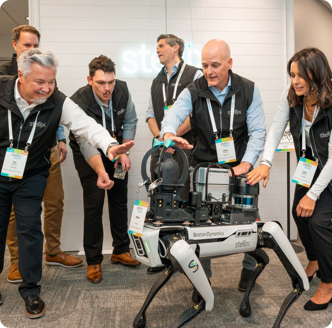 Stellix employees interacting with Stella, the Stellix site-monitoring quadruped robot.